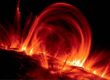 Arcing red solar prominences above Sun's surface
