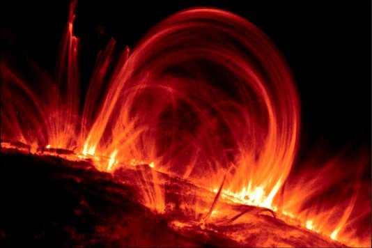 Arcing red solar prominences above Sun's surface