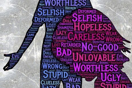 Silhouette filled with negative words reflecting self-doubt and low self-esteem.