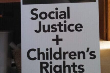 Sign advocating for social justice and children’s rights. Sign advocating for social justice and children's rights.