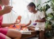 Children playing and learning chess indoors.