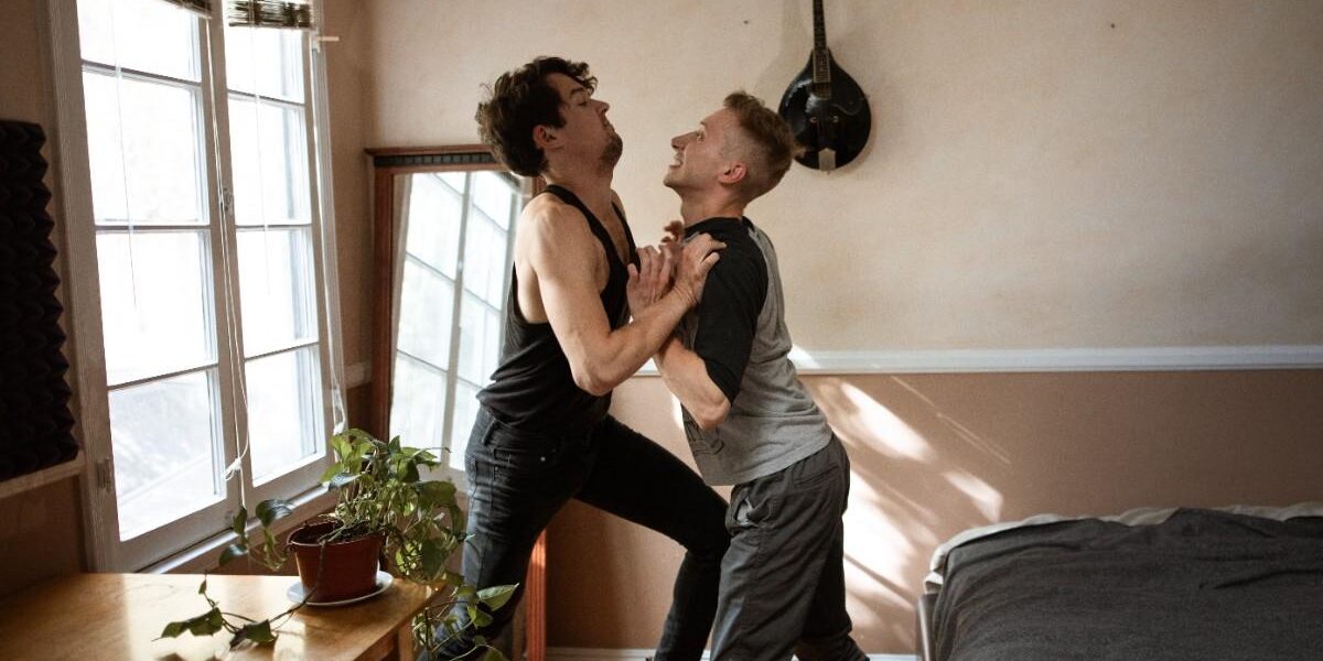 Two people dancing joyfully in a sunlit room. Two people dancing joyfully in a sunlit room.